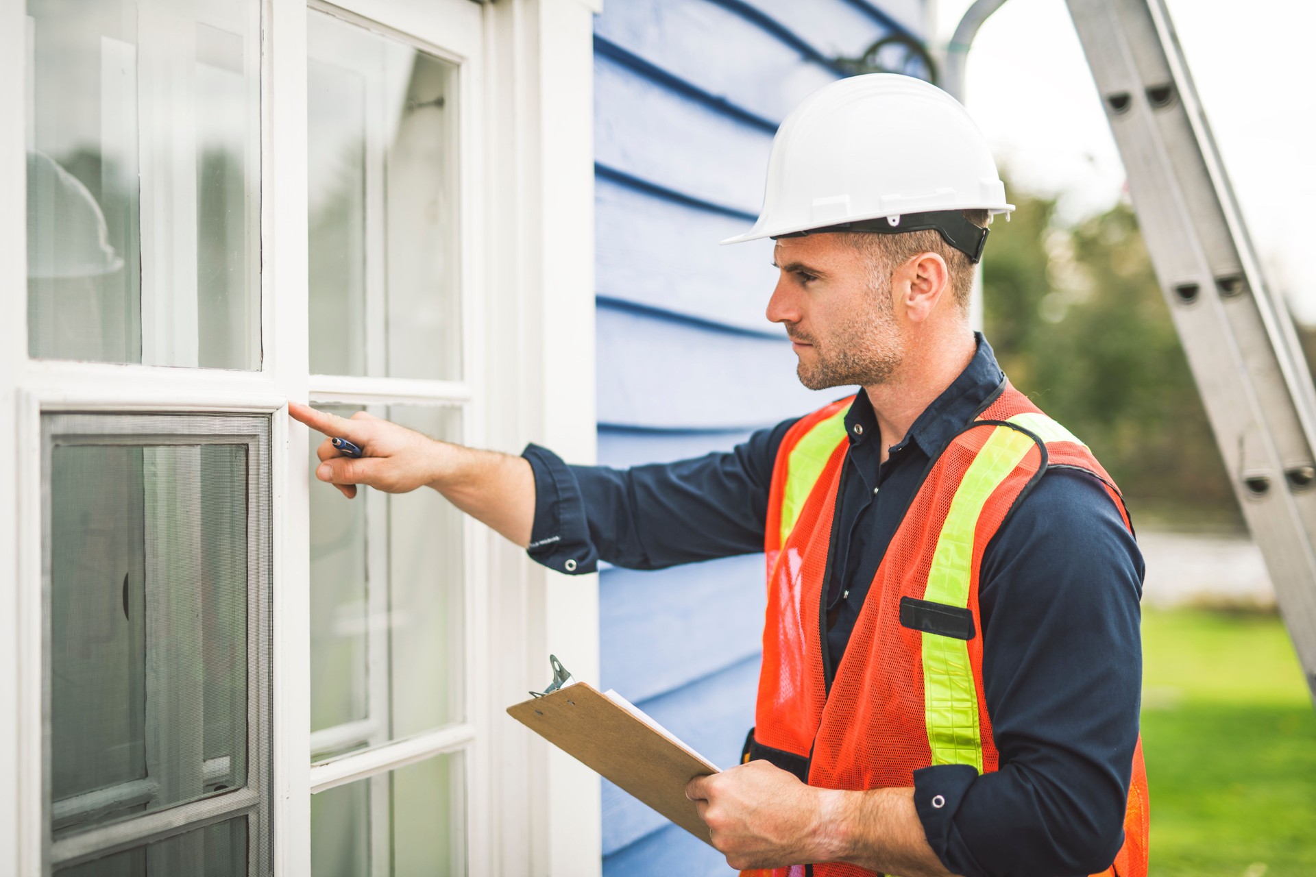 Man inspecting house window outside on day light